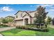Well-maintained two-story home with lush landscaping, stone accents, and a brick driveway at 1454 Belle Terre Rd, Davenport, FL 33896