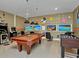 Fun game room featuring a pool table, foosball table, and arcade games for entertainment at 1454 Belle Terre Rd, Davenport, FL 33896