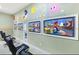 Spacious game room featuring four TVs with black swivel chairs and colorful Pac-Personal themed decor at 1454 Belle Terre Rd, Davenport, FL 33896