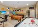 Spacious game room with a pool table, air hockey table, and arcade-themed decor at 1454 Belle Terre Rd, Davenport, FL 33896
