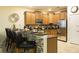 Well-equipped kitchen featuring wooden cabinetry, stainless steel appliances and a breakfast bar at 1454 Belle Terre Rd, Davenport, FL 33896