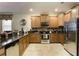Bright kitchen with stainless steel appliances, granite countertops, and ample cabinet space at 1454 Belle Terre Rd, Davenport, FL 33896