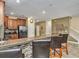 Open concept kitchen with breakfast bar, granite countertops, and stainless steel appliances at 1454 Belle Terre Rd, Davenport, FL 33896