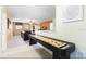 Cozy loft featuring a shuffleboard table and a comfortable leather sofa for relaxation at 1454 Belle Terre Rd, Davenport, FL 33896