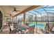 Covered patio area with ceiling fans and outdoor furniture, overlooking the screened-in pool at 1454 Belle Terre Rd, Davenport, FL 33896
