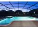 Inviting screened-in pool and spa, illuminated and ready for a relaxing evening swim at 1454 Belle Terre Rd, Davenport, FL 33896