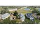Aerial view of a one-story home in a neighborhood close to the highway and a pond at 15832 Autumn Glen Ave, Clermont, FL 34714