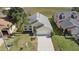 Aerial view of a well-maintained, one-story home with a manicured lawn and attached two-car garage at 15832 Autumn Glen Ave, Clermont, FL 34714