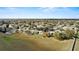 Wide angle aerial shot of a community with houses, green spaces, and mature trees at 15832 Autumn Glen Ave, Clermont, FL 34714
