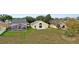 Aerial view of a home's backyard with pool, patio, and well-kept lawn at 15832 Autumn Glen Ave, Clermont, FL 34714