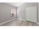 Comfortable bedroom featuring wood floors, a large window, and a closet at 15832 Autumn Glen Ave, Clermont, FL 34714