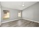 Neutral bedroom with wood floors, a ceiling fan, and natural light at 15832 Autumn Glen Ave, Clermont, FL 34714