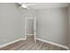 Bright bedroom with wood floors, ceiling fan, and an open doorway at 15832 Autumn Glen Ave, Clermont, FL 34714
