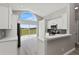 Bright kitchen with stainless steel appliances and a view of the backyard through a large window at 15832 Autumn Glen Ave, Clermont, FL 34714