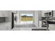 Modern kitchen featuring stainless steel appliances, gray backsplash, and sliding glass doors at 15832 Autumn Glen Ave, Clermont, FL 34714