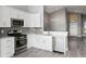 Well-equipped kitchen featuring stainless steel appliances, gray backsplash, and white cabinets at 15832 Autumn Glen Ave, Clermont, FL 34714