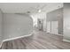 Spacious open-concept living area with gray walls, updated lighting, and new flooring at 15832 Autumn Glen Ave, Clermont, FL 34714