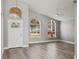 Bright living room with vaulted ceiling, large windows, and modern chandelier at 15832 Autumn Glen Ave, Clermont, FL 34714