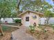 Charming backyard shed with decorative details and surrounding lush landscaping and a brick-paved pathway at 1632 Pinewood Dr, Orlando, FL 32804