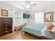 Cozy bedroom with hardwood floors, a flat-screen TV, a ceiling fan, and soft, natural light at 1632 Pinewood Dr, Orlando, FL 32804