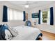 Bright bedroom features hardwood floors, a ceiling fan, a flat-screen TV, and natural light at 1632 Pinewood Dr, Orlando, FL 32804