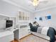 Bedroom with hardwood floors, a built-in desk, natural light, and a comfortable twin bed at 1632 Pinewood Dr, Orlando, FL 32804