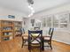 Dining room with hardwood floors, shuttered windows, modern lighting, and view of the backyard at 1632 Pinewood Dr, Orlando, FL 32804