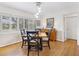 Traditional dining room featuring hardwood floors, large windows, and a charming wooden sideboard at 1632 Pinewood Dr, Orlando, FL 32804