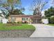 Charming single-story home featuring a well-manicured front yard and screened front porch, creating an inviting curb appeal at 1632 Pinewood Dr, Orlando, FL 32804