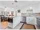Bright, open kitchen featuring sleek white cabinets, elegant marble countertops, and stainless steel appliances, great for entertaining at 1632 Pinewood Dr, Orlando, FL 32804
