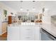 Bright kitchen features a marble countertop island with drawers, stainless steel appliances, and sleek white cabinetry at 1632 Pinewood Dr, Orlando, FL 32804