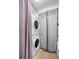 Laundry room with stacked washer and dryer units, tile flooring, and access to the exterior at 1632 Pinewood Dr, Orlando, FL 32804