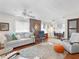 Spacious living room featuring a decorative brick accent wall, plush seating, and a view into the cozy dining area at 1632 Pinewood Dr, Orlando, FL 32804