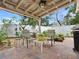 Relaxing outdoor patio with brick flooring, comfortable seating, and lush landscaping at 1632 Pinewood Dr, Orlando, FL 32804