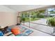 Relaxing screened porch with comfortable seating and views of the landscaped yard and quiet street, perfect for unwinding at 1632 Pinewood Dr, Orlando, FL 32804