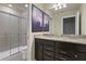 Well-lit bathroom featuring double sinks, granite countertops, and a glass shower for a modern and clean look at 2217 Lelani Cir, Davenport, FL 33897