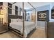 Luxurious bedroom featuring a canopy bed, stylish decor, and an en-suite bathroom with a glass-enclosed shower at 2217 Lelani Cir, Davenport, FL 33897