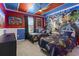 Themed bedroom featuring two twin beds with Avenger's bedding and vibrant superhero wall decor and ceiling fan at 2217 Lelani Cir, Davenport, FL 33897