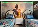 Star Wars themed bedroom featuring twin beds with headboards and themed wallpaper and ceiling at 2217 Lelani Cir, Davenport, FL 33897