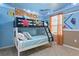 Nautical themed bunk bedroom featuring custom mural, lower full bed, and window at 2217 Lelani Cir, Davenport, FL 33897