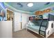 Nautical themed bunk bedroom featuring custom mural, lower full bed and closet at 2217 Lelani Cir, Davenport, FL 33897