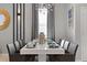 Elegant dining room with modern chandelier and seating for ten at 2217 Lelani Cir, Davenport, FL 33897