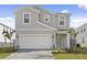 Two-story home boasting a two-car garage and manicured landscaping at 2217 Lelani Cir, Davenport, FL 33897