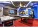 Entertainment-themed game room featuring an air hockey table, pool table, and large screen TV at 2217 Lelani Cir, Davenport, FL 33897