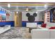 Whimsical game room with bright colors, Mickey Mouse accents, and comfortable seating at 2217 Lelani Cir, Davenport, FL 33897
