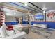 Themed recreation room with colorful accents, comfortable seating, and a large screen TV for entertainment at 2217 Lelani Cir, Davenport, FL 33897