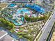 Aerial view of a resort-style community pool, water slides, mini golf, and clubhouse at 2221 Lelani Cir, Davenport, FL 33897