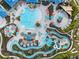 Aerial view of an amazing community pool and splash pad with cabanas and seating at 2221 Lelani Cir, Davenport, FL 33897