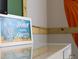 Charming 'Ohana Means Gathering' art print decorates a dresser, adding a touch of warmth to the room at 2221 Lelani Cir, Davenport, FL 33897