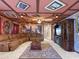 Unique basement featuring a large sectional sofa, TV, themed art, and detailed ceiling design at 2221 Lelani Cir, Davenport, FL 33897